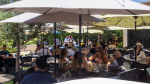 Guests enjoy dining outdoors in Santa Paula at Parque 1055 on a warm sunny day